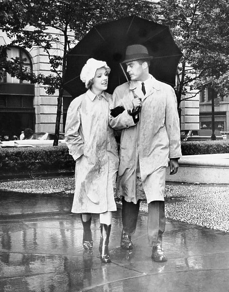 Couple w  /  umbrella walking in the rain