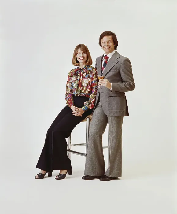 Framed Print : Couple on white background, man holding drink Framed Print : Couple on white background, man holding drink