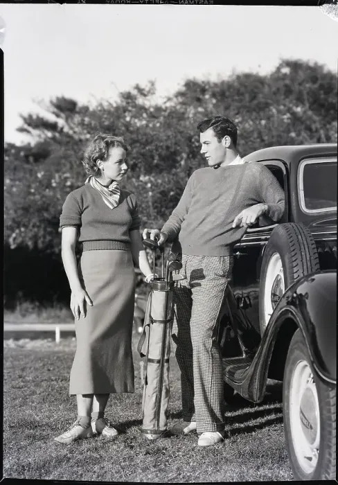 Framed Print : Couple of Young Golfers Standing by Car Framed Print : Couple of Young Golfers Standing by Car