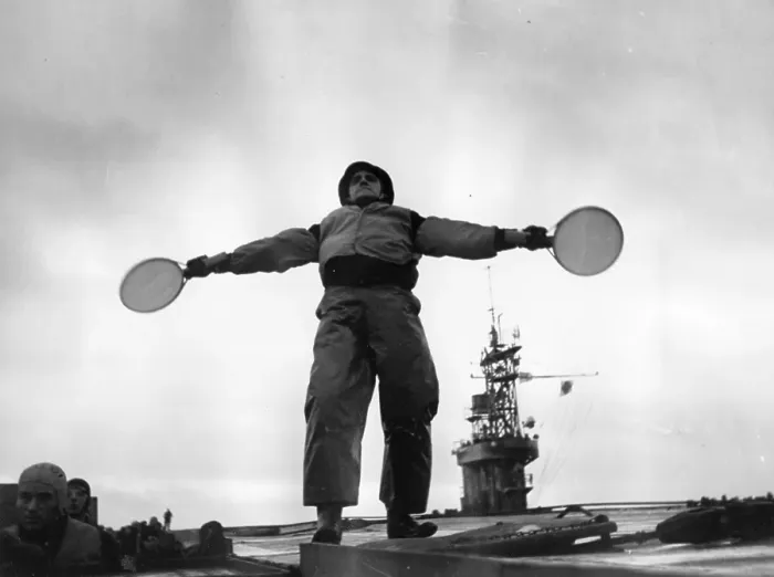 Framed Print : On Course. 15th January 1944: A landing control officer signals with bats Framed Print : On Course. 15th January 1944: A landing control officer signals with bats