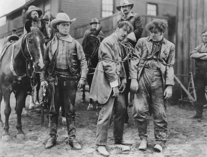 Framed Print : Cowboy Arresting Two Men; Tied Up Framed Print : Cowboy Arresting Two Men; Tied Up