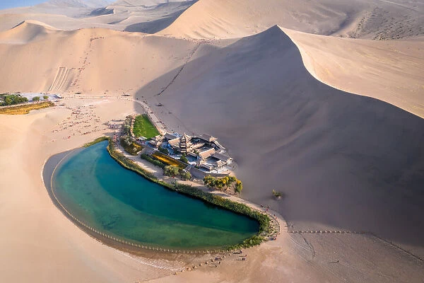Crescent Lake with buddhist temple in Kumtag desert, Dunhuang, Gansu China