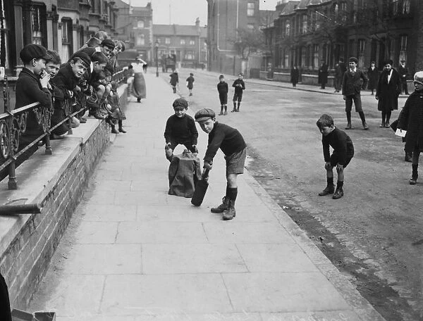 Cricket. 6th March 1926: Young boys playing cricket in a London street