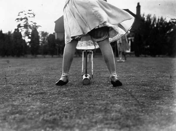 Croquet. circa 1930: A woman playing croquet