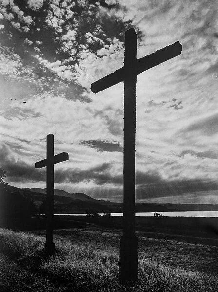 Crosses. circa 1930: Two crosses silhouetted aganist a windswept sky in