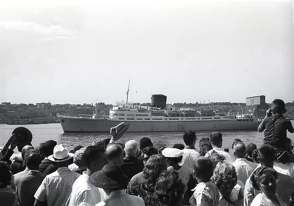Crowd in harbor waiting for steamship