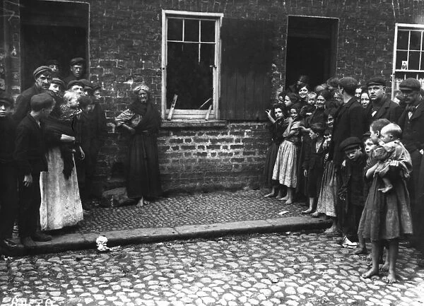 A crowd inspects damage to a house by a regiment of soldiers at Donegal Quay