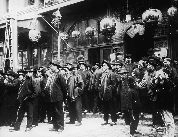 A Crowd Of Men On The Street In Chinatown
