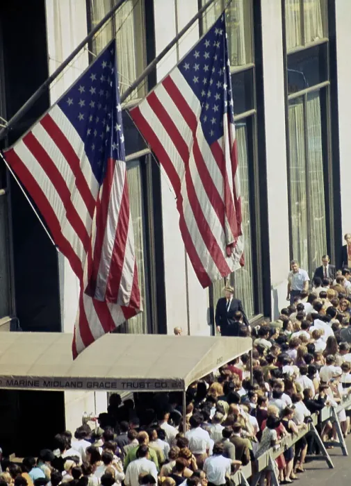 Framed Print : Crowds Queueing Below American Flags Framed Print : Crowds Queueing Below American Flags