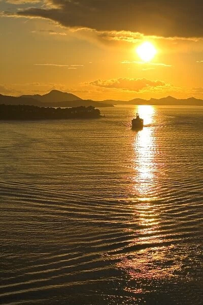 Cruise ship sails into sunset, Port of Dubrovnik, Croatia