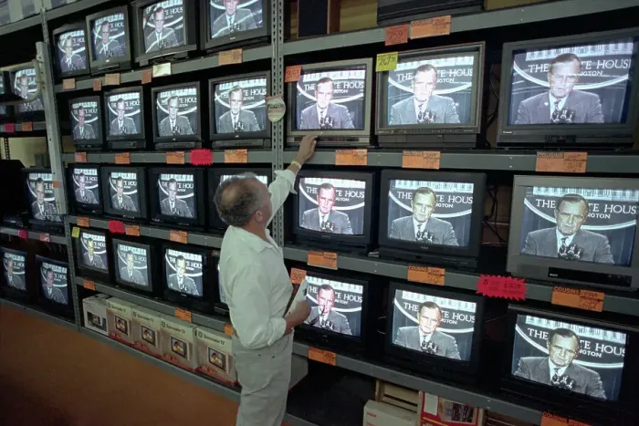 Framed Print : Customer Watching George Bush on Television Framed Print : Customer Watching George Bush on Television
