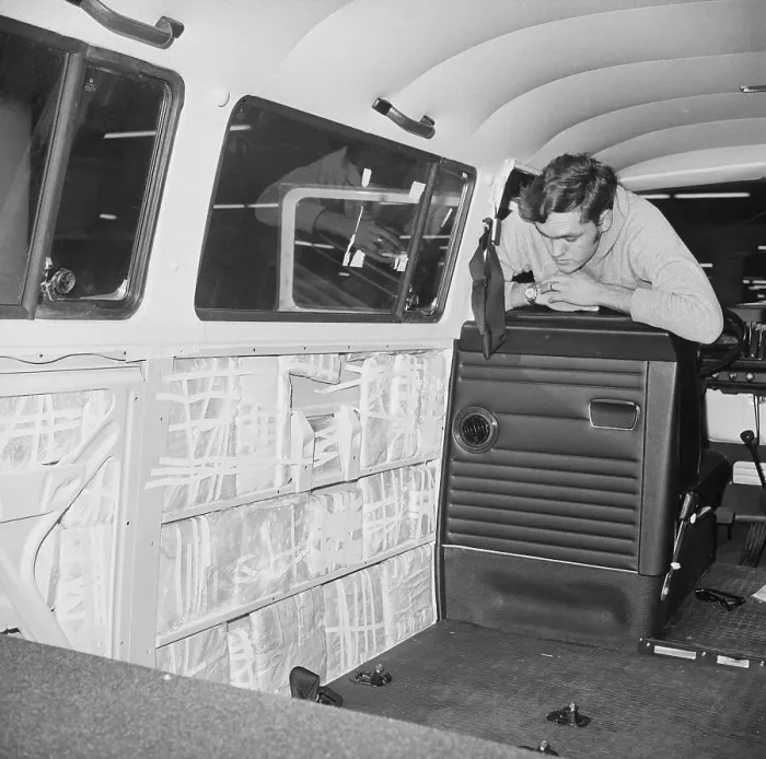 Framed Print : Customs Inspector Looks At Bus Panels Framed Print : Customs Inspector Looks At Bus Panels