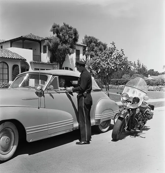Framed Print : Cycle Cop. A motorcycle policeman checking the driving licence of a man Framed Print : Cycle Cop. A motorcycle policeman checking the driving licence of a man