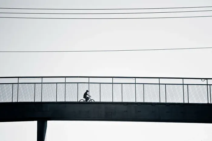 Framed Print : Cyclist crossing bridge Framed Print : Cyclist crossing bridge