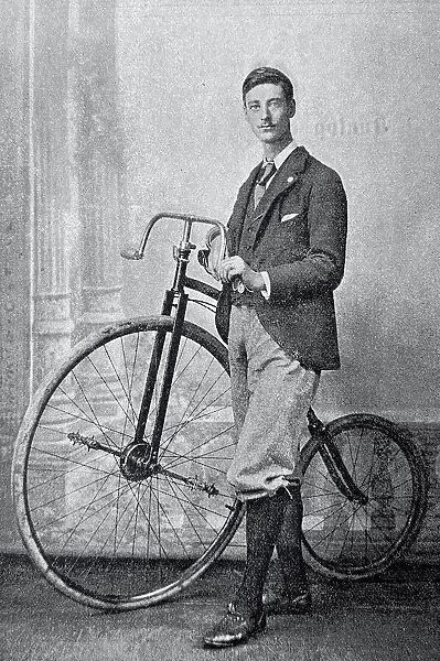Cyclist F. W. Shorland, England, standing aside of his bicycle, dressed elegantly