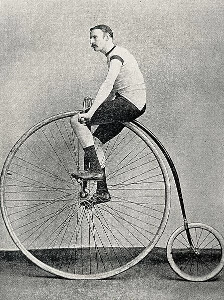 Cyclist J. H. Adams on a penny farthing bicycle, side view