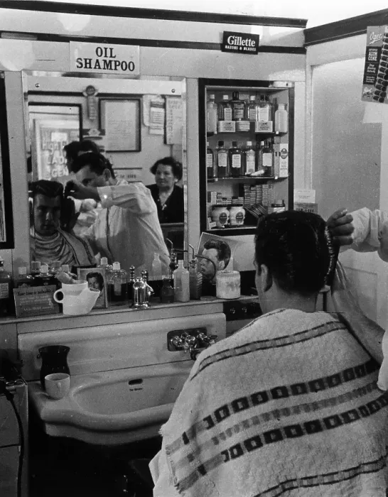 Framed Print : DA Cut. 13th November 1954: Barber Angel Rose sculpts a customer's hair into a DA style Framed Print : DA Cut. 13th November 1954: Barber Angel Rose sculpts a customer's hair into a DA style