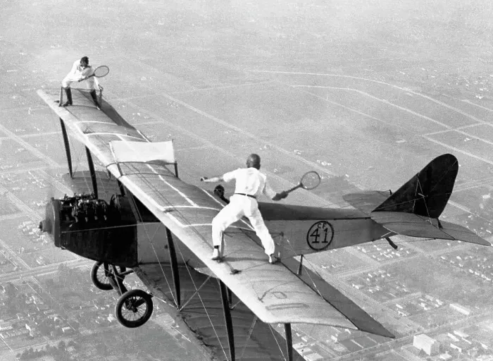 Framed Print : Daredevils Playing Tennis on a Biplane Framed Print : Daredevils Playing Tennis on a Biplane