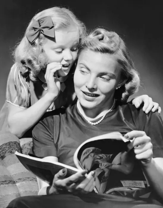 Framed Print : Daughter whispering into mothers ear Framed Print : Daughter whispering into mothers ear