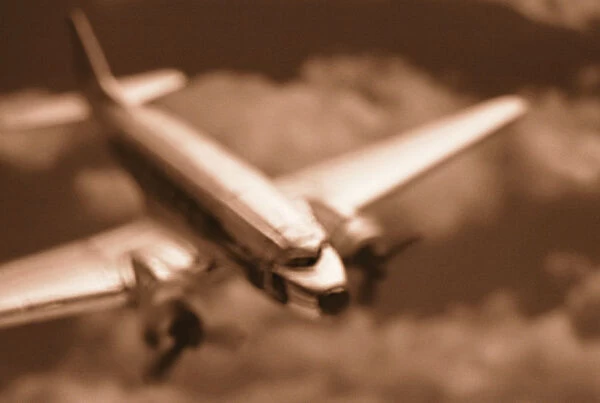 Dc 3 Flying in Clouds in Sepia