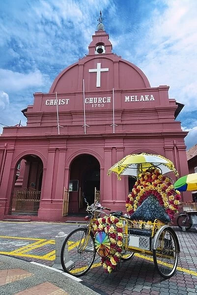 Decorated trishaw in front of Christ Church Melaka