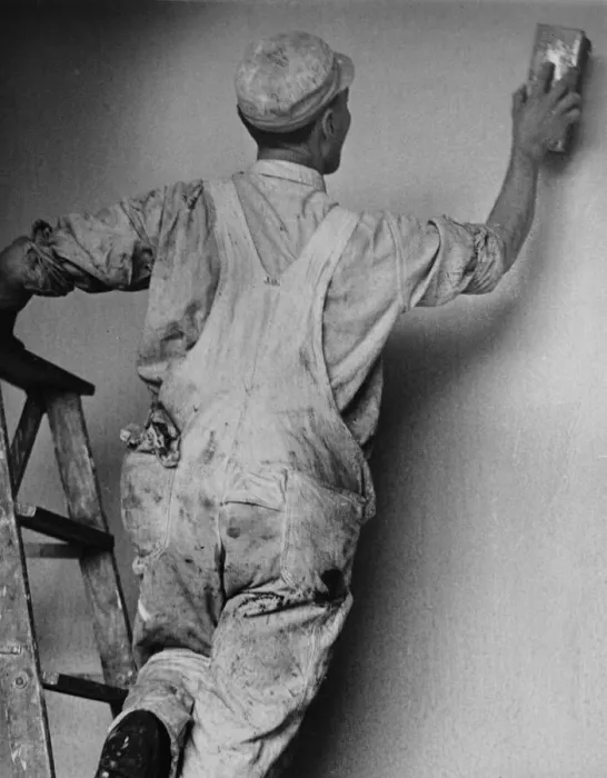 Framed Print : Decorator. A decorator smooths the plaster of a new wall, circa 1950 Framed Print : Decorator. A decorator smooths the plaster of a new wall, circa 1950