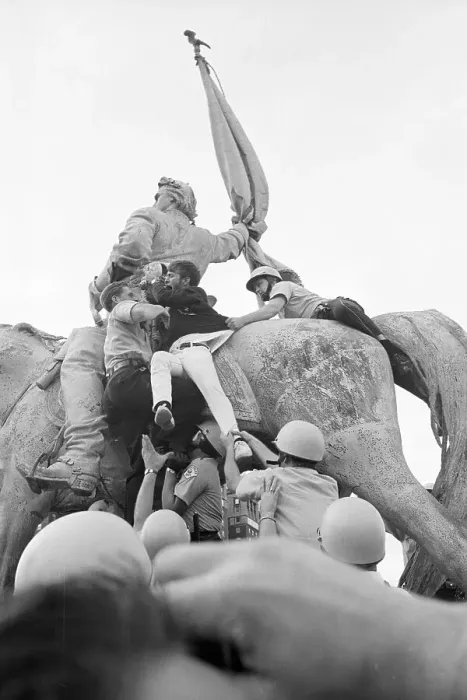 Framed Print : Demonstrator Climbing On Statue Framed Print : Demonstrator Climbing On Statue