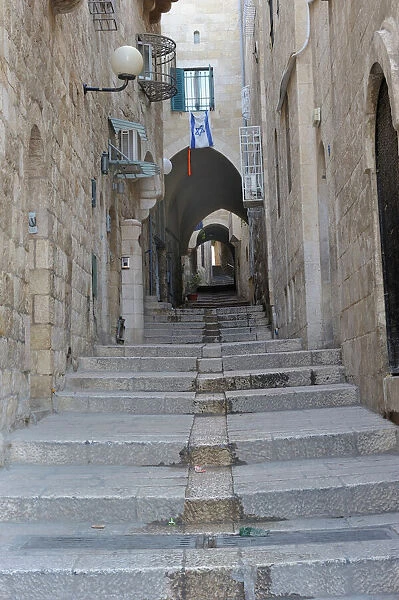 Deserted alleyway with Israeli flag hanging from a window above an archway, Muslim Quarter, Old City, Jerusalem, Middle East