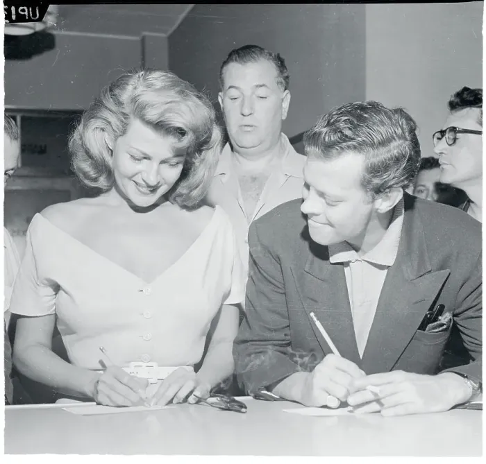 Framed Print : Dick Haymes and Jack Entratter Watching Rita Hayworth Sign