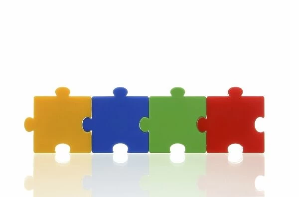 Four different coloured puzzle pieces, connected, symbolic image, team, series