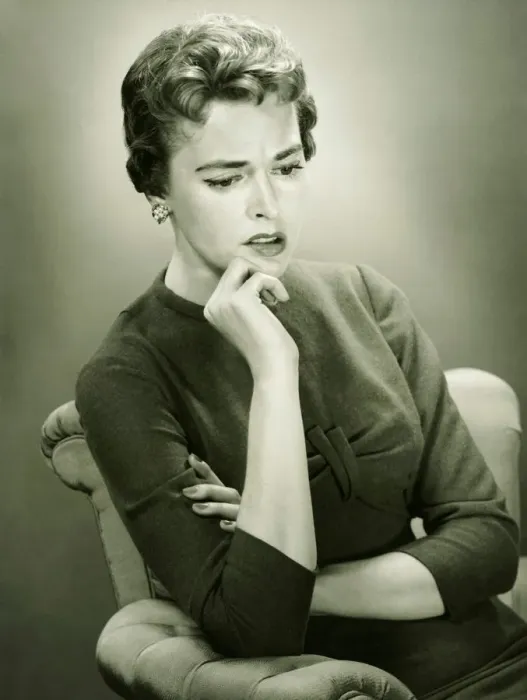 Framed Print : Distraught woman sitting in armchair in studio, (B&W), portrait Framed Print : Distraught woman sitting in armchair in studio, (B&W), portrait
