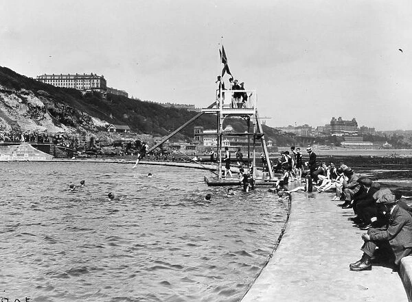 Divers. circa 1917: The diving board at the bathing pool at the South Cliff