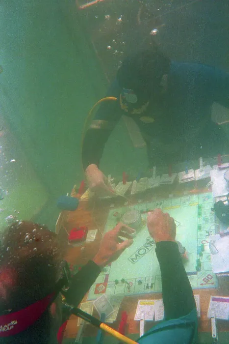 Framed Print : Divers Playing Monopoly Underwater Framed Print : Divers Playing Monopoly Underwater