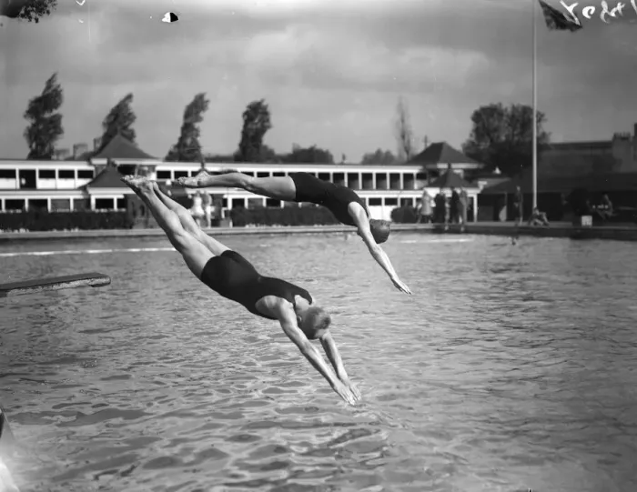 Framed Print : Diving. 1929: A man and a woman diving into a pool from a diving board Framed Print : Diving. 1929: A man and a woman diving into a pool from a diving board