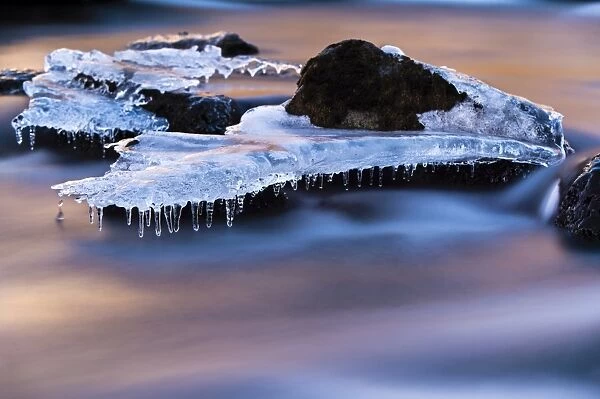Djupin river, with ice and rocks at sunrise, Vik, Iceland