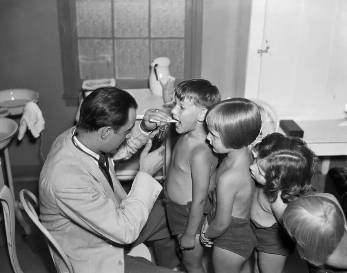 Framed Print : Doctor Checks Children For TB Symptoms Framed Print : Doctor Checks Children For TB Symptoms