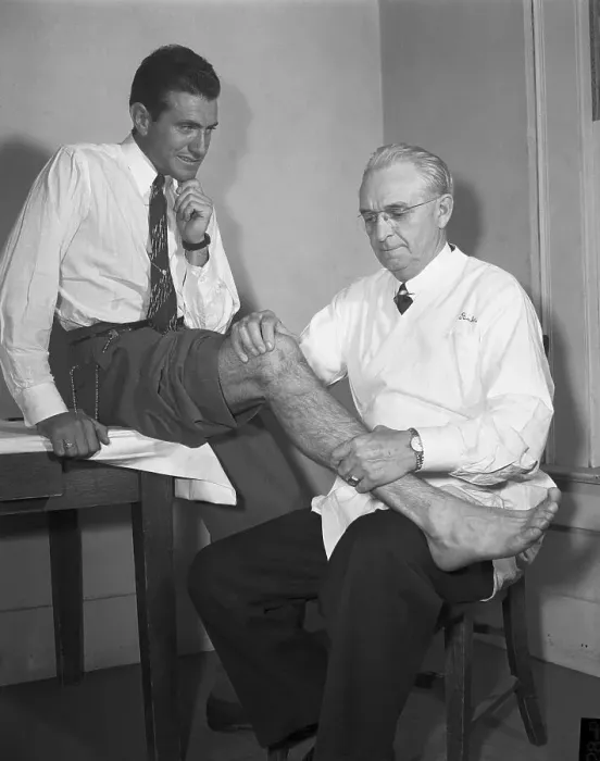 Framed Print : Doctor examining leg of runner Louis Zamperini Framed Print : Doctor examining leg of runner Louis Zamperini