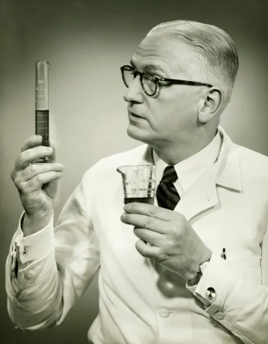 Framed Print : Doctor holding buretts in studio, (B&W), portrait Framed Print : Doctor holding buretts in studio, (B&W), portrait