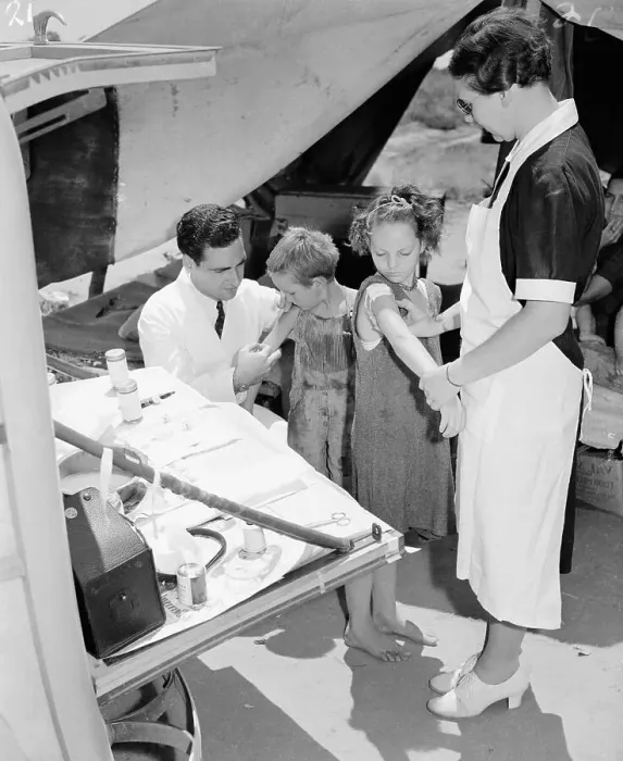 Framed Print : Doctor and Nurse Vaccinate Migrant Children Framed Print : Doctor and Nurse Vaccinate Migrant Children