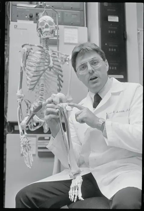Framed Print : Doctor Pointing to Area on Skeleton Framed Print : Doctor Pointing to Area on Skeleton
