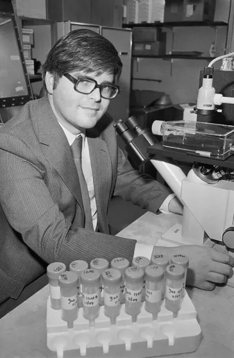 Framed Print : Doctor Smiling at Desk with Blood Samples Framed Print : Doctor Smiling at Desk with Blood Samples