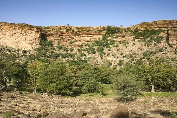 Dogon village of Banani with ancient Tellem dwellings underneath the Bandiagara Escarpment