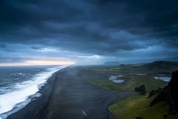 Dramatic clouds, black sandy beach near Dyrholaey, south coast, Southern Region, Iceland