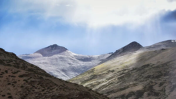 dramatic landscape sunlight on snow capped mountain peak on the way to leh ladakh, jammu and kashmir, india