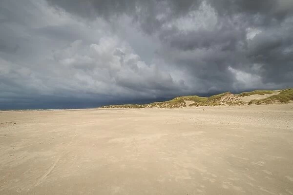 Dramatic storm clouds over beach and dunes, Henne Strand, Region of Southern Denmark, Denmark