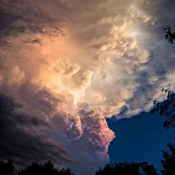 Dramatic storm clouds rolling in at sunset before