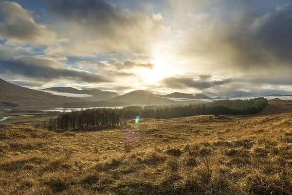 Dramatic sunset with atmospheric clouds over the mountainous Scottish landscape