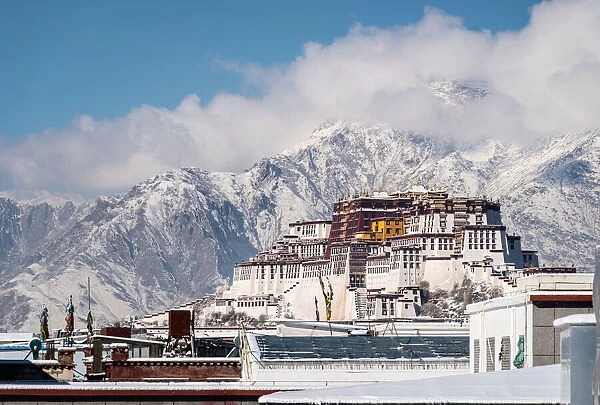 Dramatic view of the Potala Palace rising above the roofs of Lhasa in Tibet