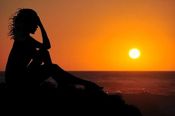 Dramatic woman watching beautiful sunset
