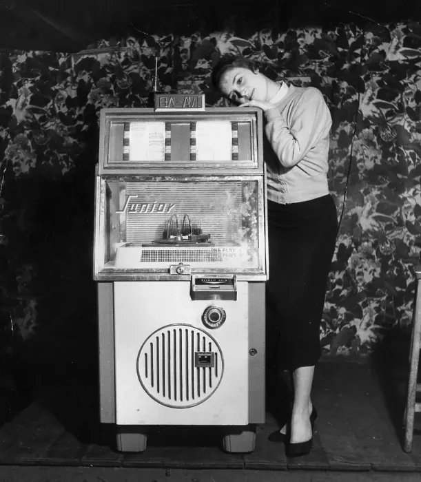 Framed Print : Dream On. February 1957: A young woman gets dewy-eyed with the music from a juke box Framed Print : Dream On. February 1957: A young woman gets dewy-eyed with the music from a juke box